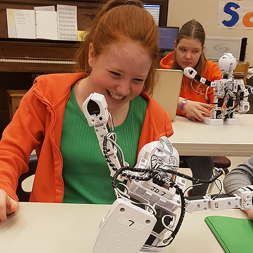 Girls working with JD Humanoid Robot